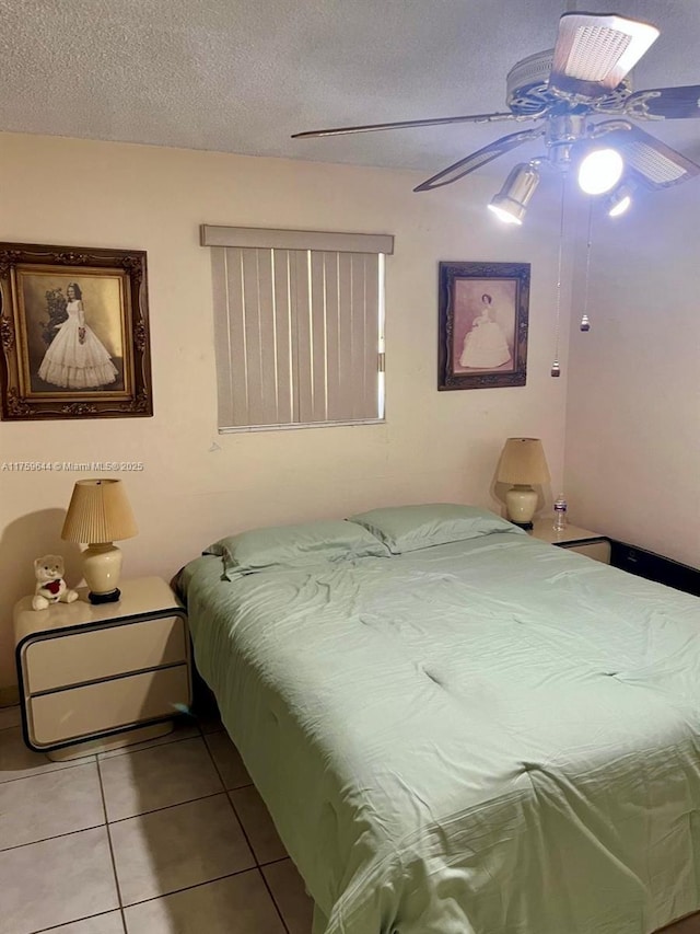 bedroom featuring tile patterned floors, a textured ceiling, and ceiling fan