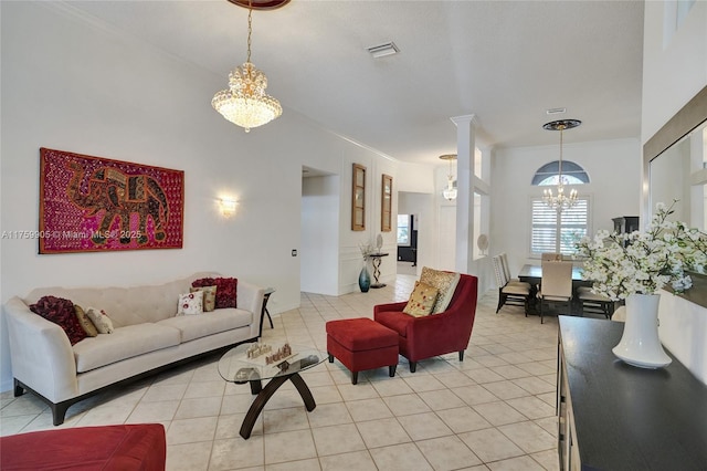 living room with a notable chandelier, light tile patterned floors, crown molding, and visible vents