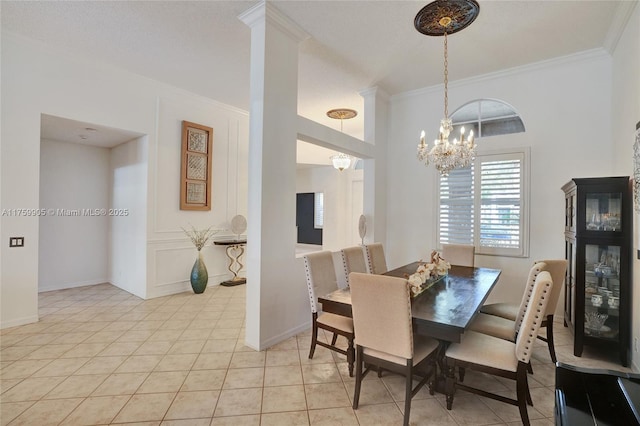 dining space featuring an inviting chandelier, light tile patterned flooring, baseboards, and ornamental molding