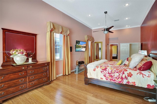 bedroom featuring crown molding, light wood-style flooring, baseboards, and visible vents