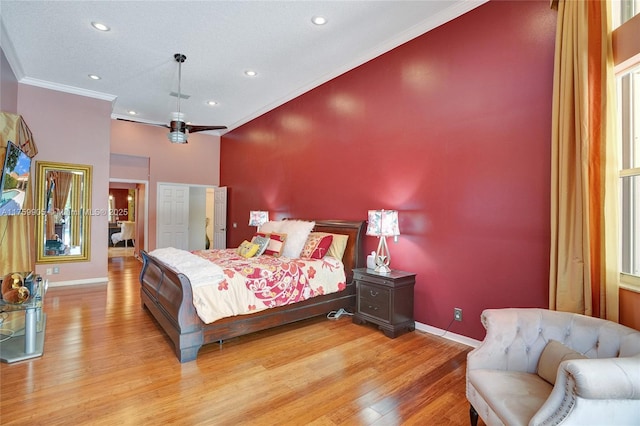 bedroom featuring recessed lighting, light wood-type flooring, crown molding, and baseboards