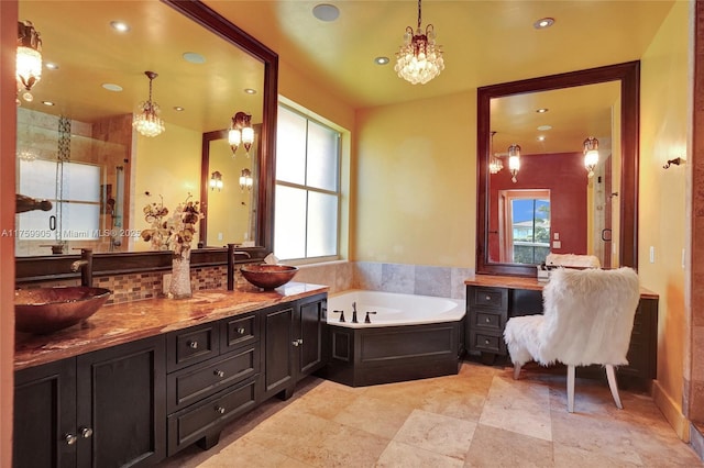 bathroom featuring a sink, a garden tub, recessed lighting, and double vanity