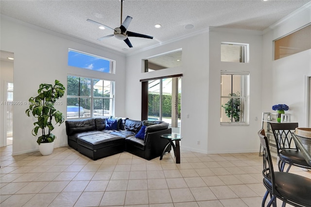 living area featuring light tile patterned floors, baseboards, a textured ceiling, and ornamental molding