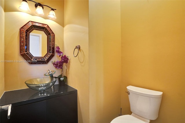 bathroom featuring toilet and vanity