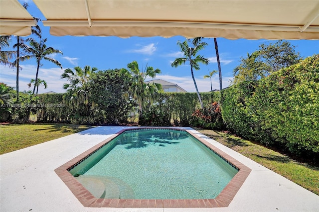 view of swimming pool with a fenced in pool, a lawn, and a fenced backyard