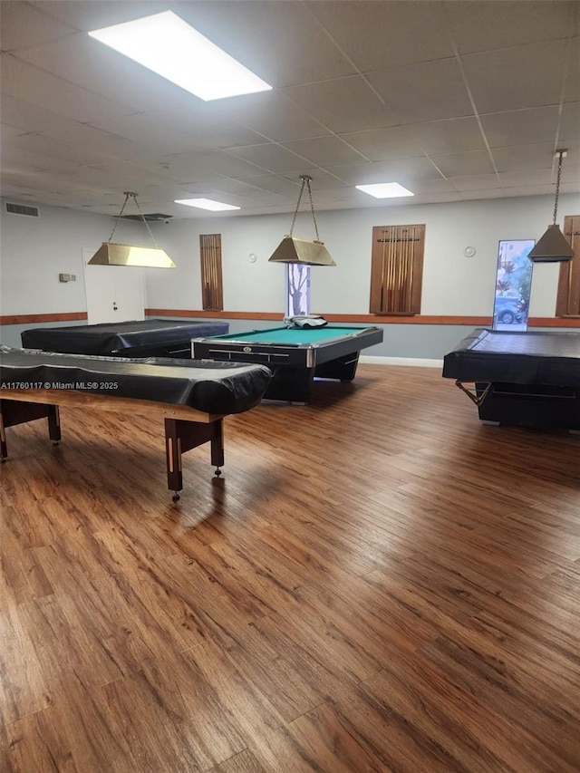 game room featuring visible vents, pool table, baseboards, a drop ceiling, and wood finished floors