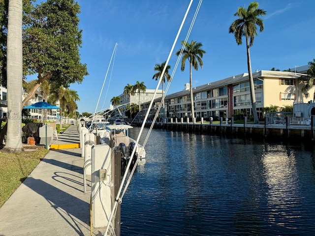 dock area with a residential view and a water view