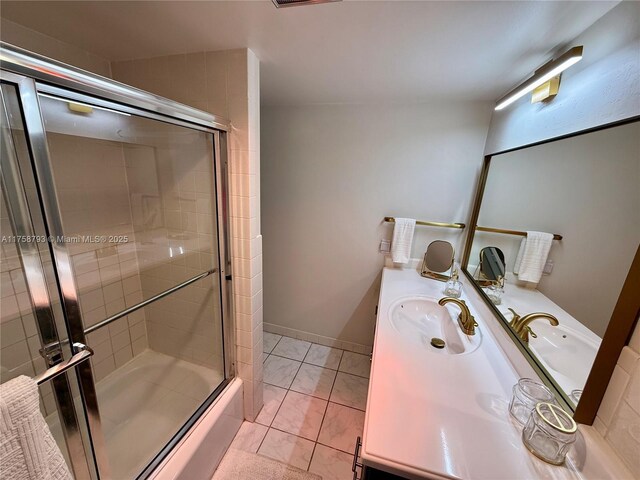 full bathroom with baseboards, shower / bath combination with glass door, tile patterned flooring, and vanity