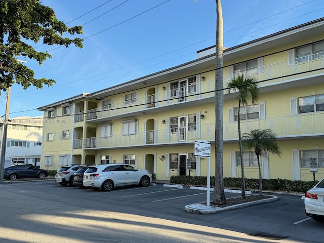 view of building exterior with uncovered parking