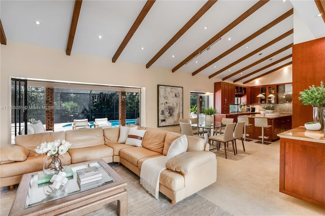 living room with beamed ceiling, recessed lighting, and high vaulted ceiling