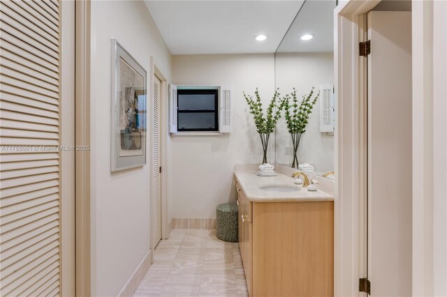 5780 Magnolia Ln, Coral Gables, FL 33156 - bathroom with vanity, recessed lighting, baseboards, marble look tiles, and a closet