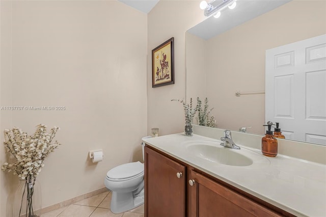 bathroom with tile patterned floors, toilet, vanity, and baseboards