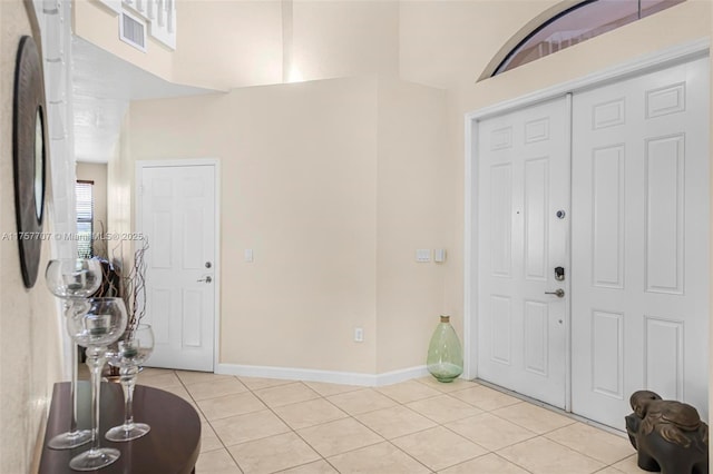 foyer entrance featuring visible vents, baseboards, and light tile patterned flooring