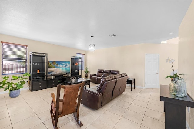 living room featuring light tile patterned flooring, baseboards, and visible vents