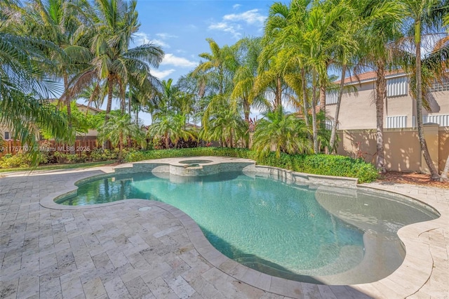 view of pool with a pool with connected hot tub and a patio area