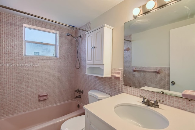 full bath with vanity, tile walls, toilet, and washtub / shower combination