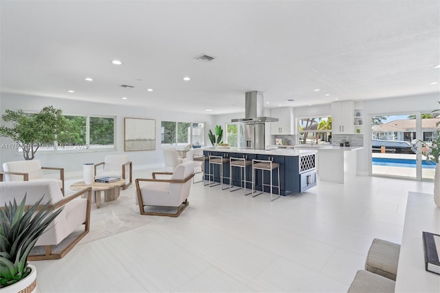 living area with recessed lighting and visible vents