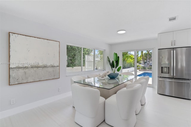 dining space with baseboards and visible vents