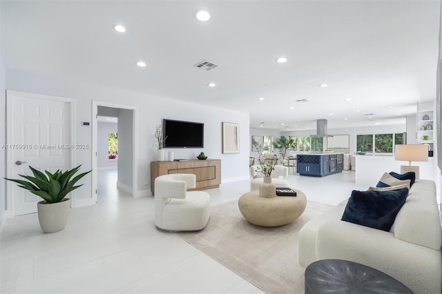 living room featuring recessed lighting, visible vents, baseboards, and light tile patterned floors