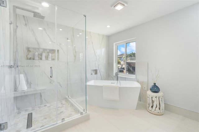 bathroom featuring recessed lighting, a marble finish shower, and a soaking tub