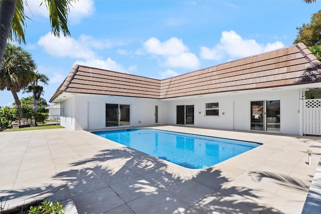 pool with fence and a patio area