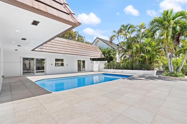 view of swimming pool with a patio area, a fenced in pool, and fence