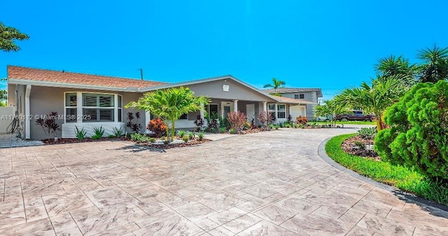 single story home with stucco siding and driveway