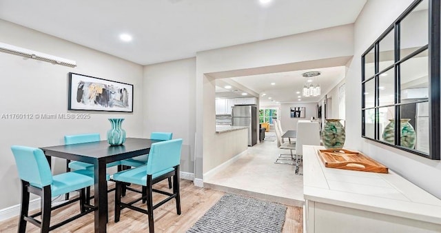 dining area featuring recessed lighting, light wood-type flooring, and baseboards