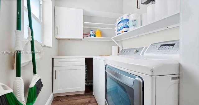 laundry room featuring dark wood-type flooring, cabinet space, and separate washer and dryer