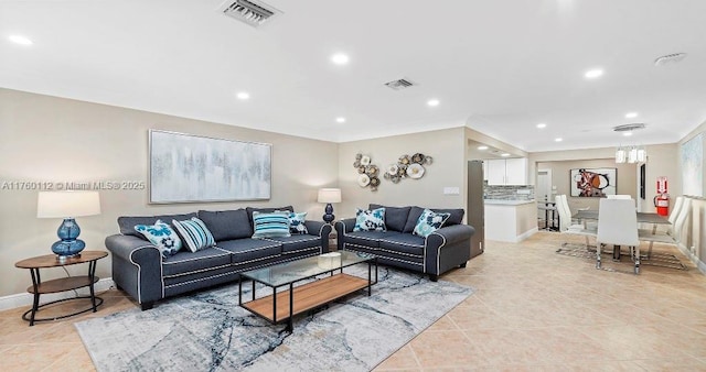 living area with light tile patterned floors, recessed lighting, visible vents, and baseboards