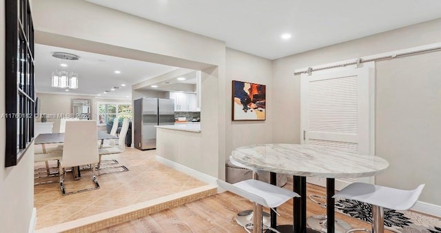 dining space featuring recessed lighting, baseboards, and light tile patterned floors