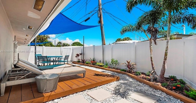 view of patio / terrace with a fenced backyard, outdoor dining space, and a deck