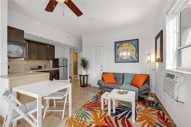 living area featuring light tile patterned floors, cooling unit, and a ceiling fan