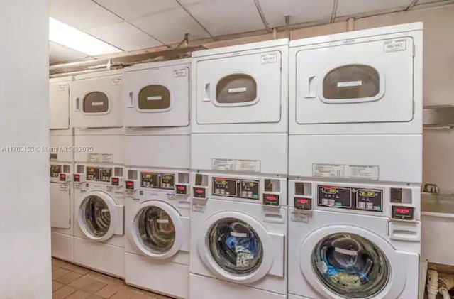 community laundry room featuring stacked washer / drying machine and washer and clothes dryer