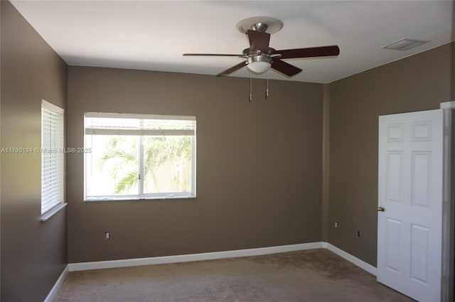 unfurnished room featuring baseboards, visible vents, carpet floors, and ceiling fan