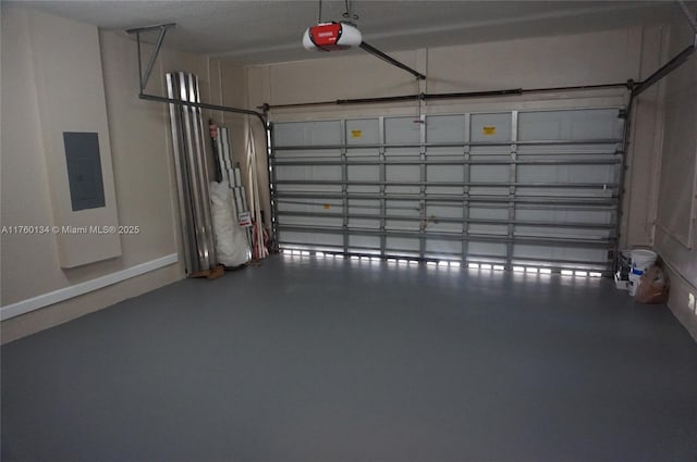 garage with electric panel, a garage door opener, and baseboards