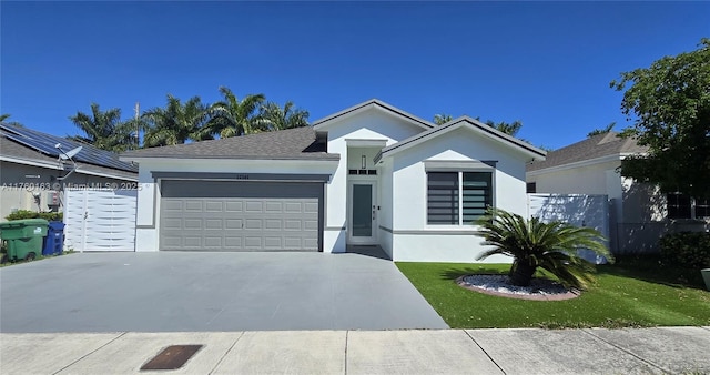 ranch-style home featuring stucco siding, a garage, and driveway