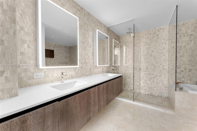 68 SE 6th St Unit 1404, Miami, FL 33131 - full bath featuring double vanity, a stall shower, tile walls, and a sink