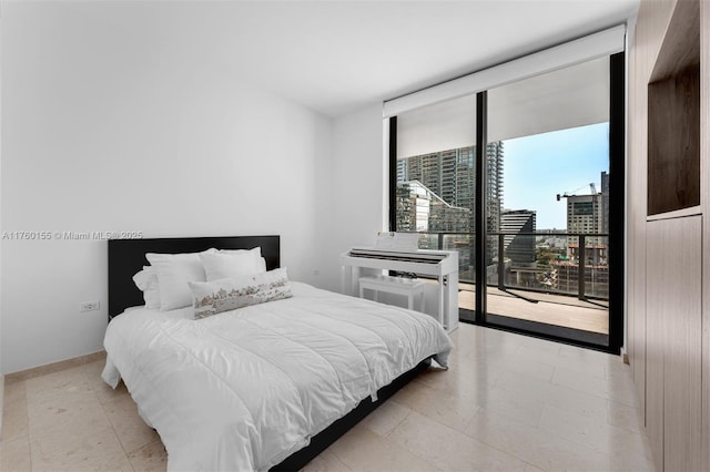 68 SE 6th St Unit 1404, Miami, FL 33131 - bedroom featuring a wall of windows, baseboards, a view of city, and access to outside