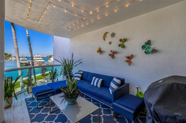 balcony with an outdoor living space and a water view