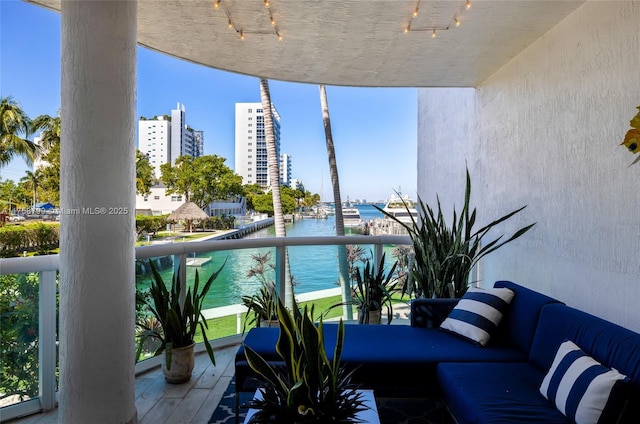 balcony featuring a view of city and a water view