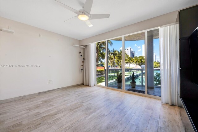 unfurnished room with ceiling fan and light wood finished floors