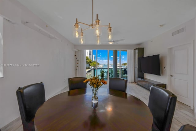 dining space featuring visible vents and an inviting chandelier