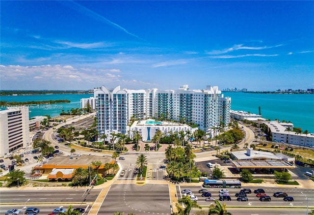 drone / aerial view with a city view and a water view