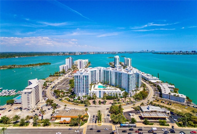 drone / aerial view featuring a city view and a water view