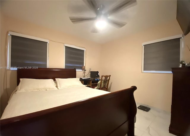 bedroom with marble finish floor and ceiling fan