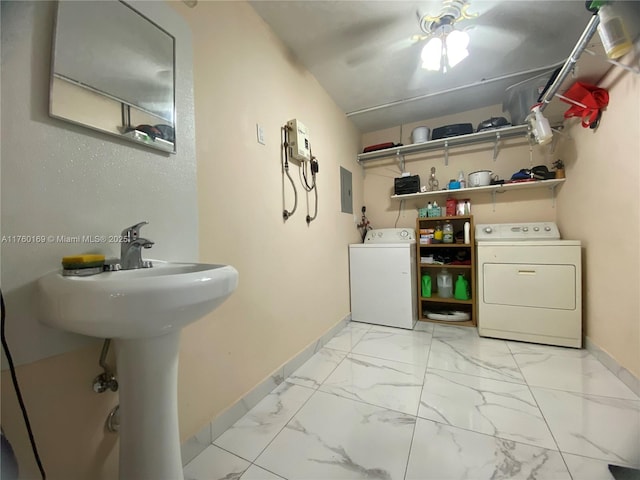 bathroom with electric panel, washing machine and dryer, marble finish floor, and baseboards