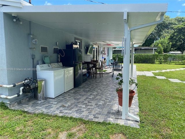 view of patio / terrace featuring area for grilling and washing machine and dryer