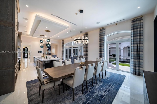 dining room featuring light tile patterned floors, recessed lighting, french doors, an inviting chandelier, and a raised ceiling