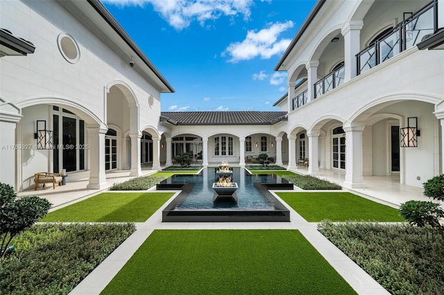 exterior space with french doors and a lawn